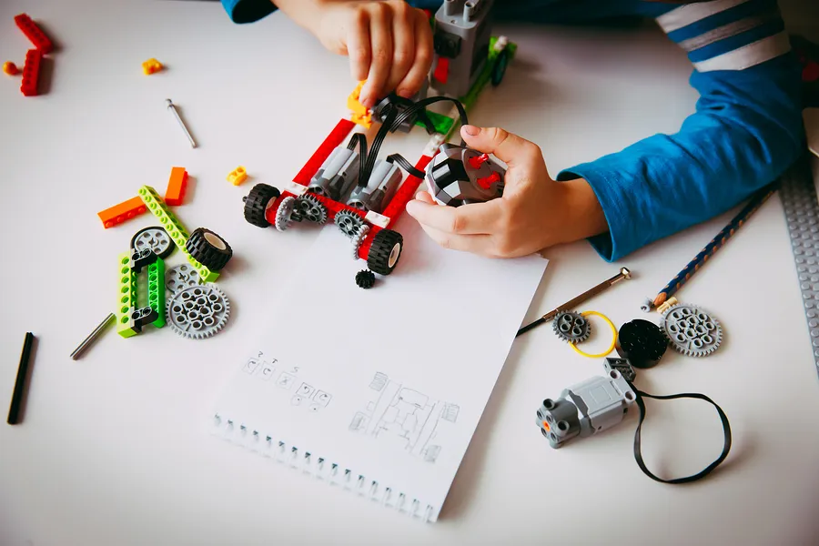bigstock-Little-Boy-Building-Robot-At-R-227697319